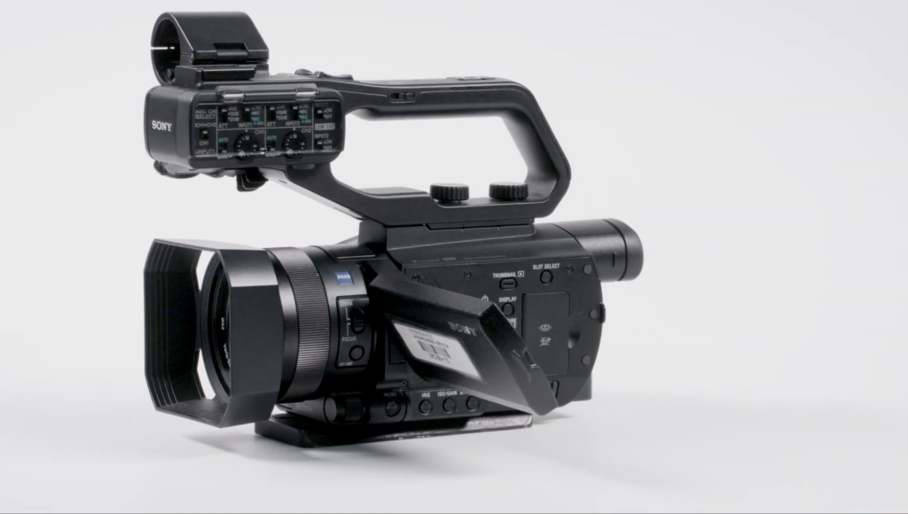 A black professional Sony video camera on a white background.